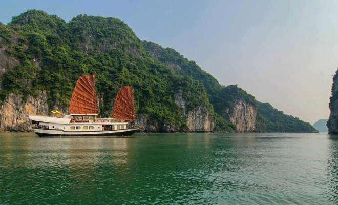 Ha Long Bay small junk on emerald waters