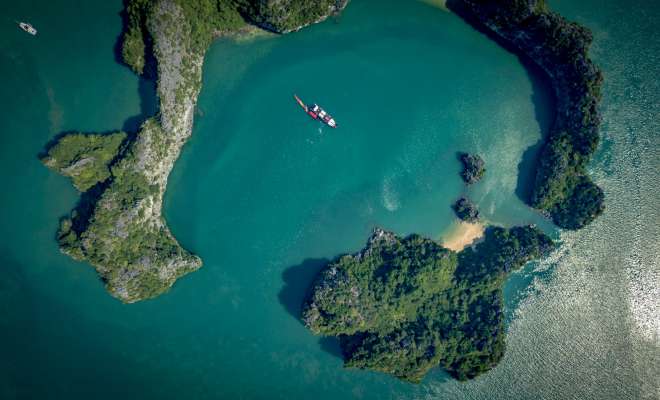 Bai Tu Long Bay - emerald lagoon with boat and canoe